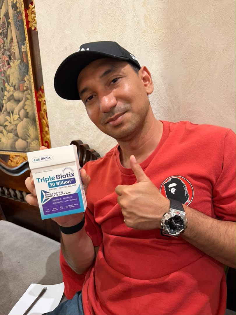 Zizan Razak, duta produk, memberi tunjuk jempol sambil memegang kotak TripleBiotix